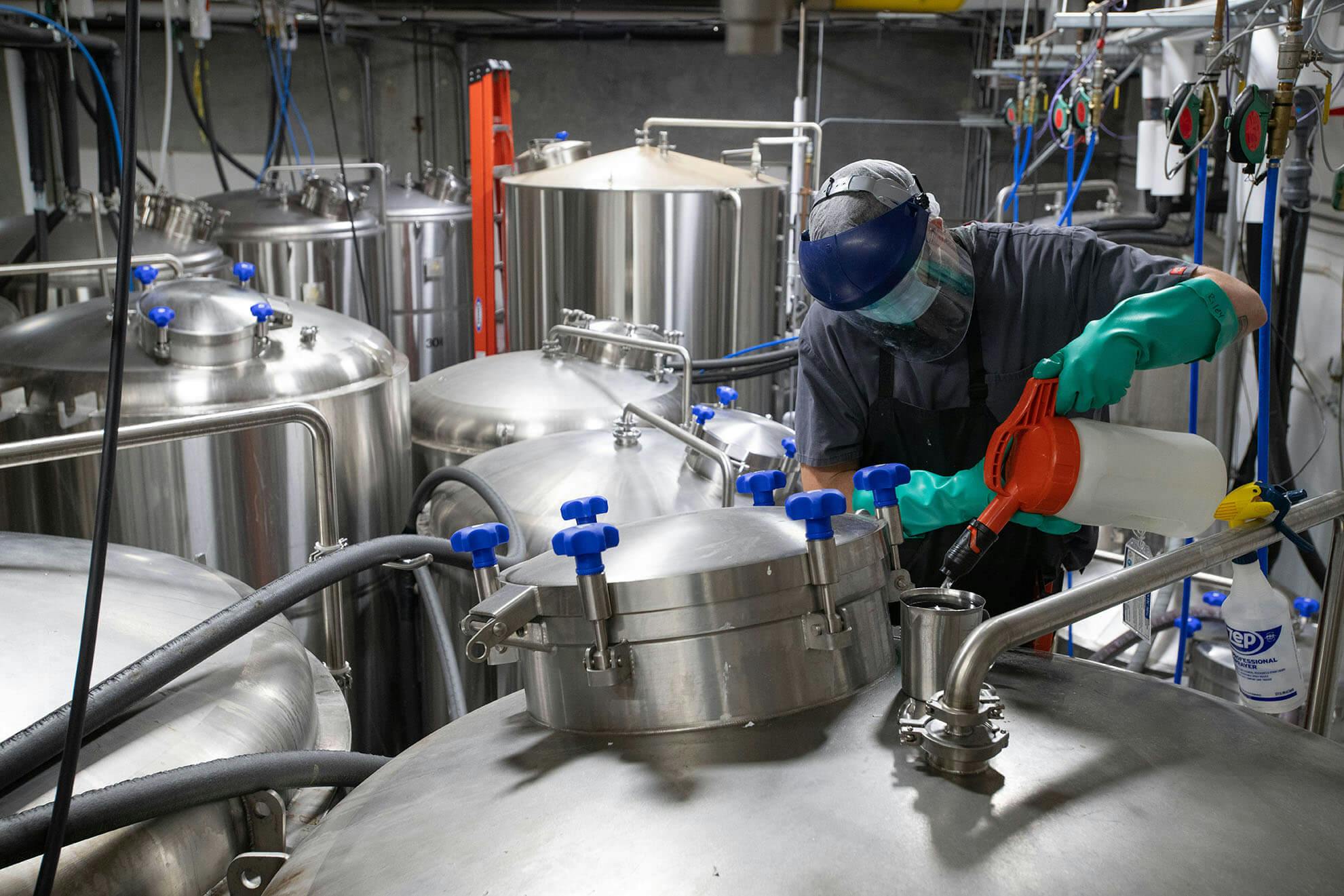 Brewer wearing protective gear operating at an Imperial Yeast facility.
